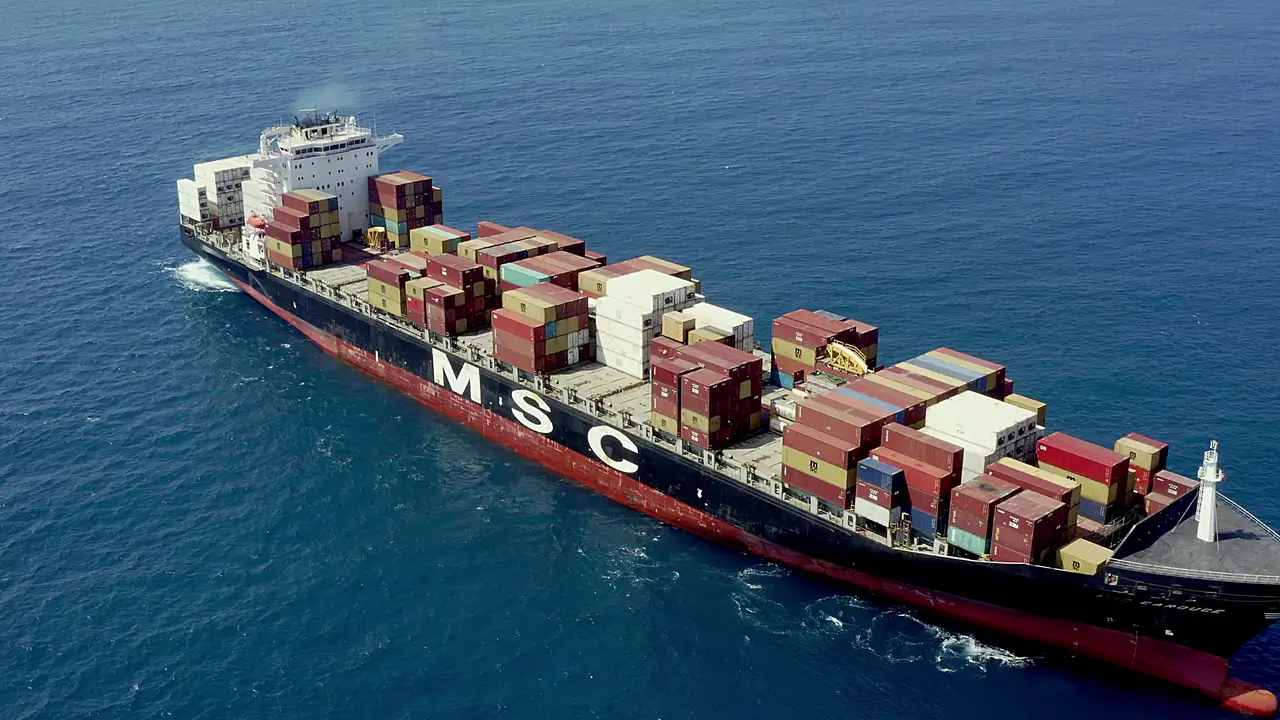 A bulk carrier alongside a berth with hatch covers open